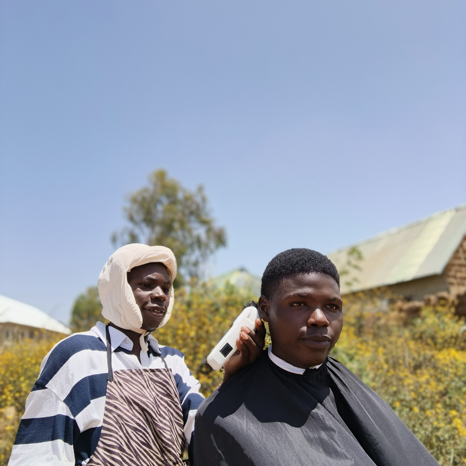 Barber giving a client a fade at JhayCutz